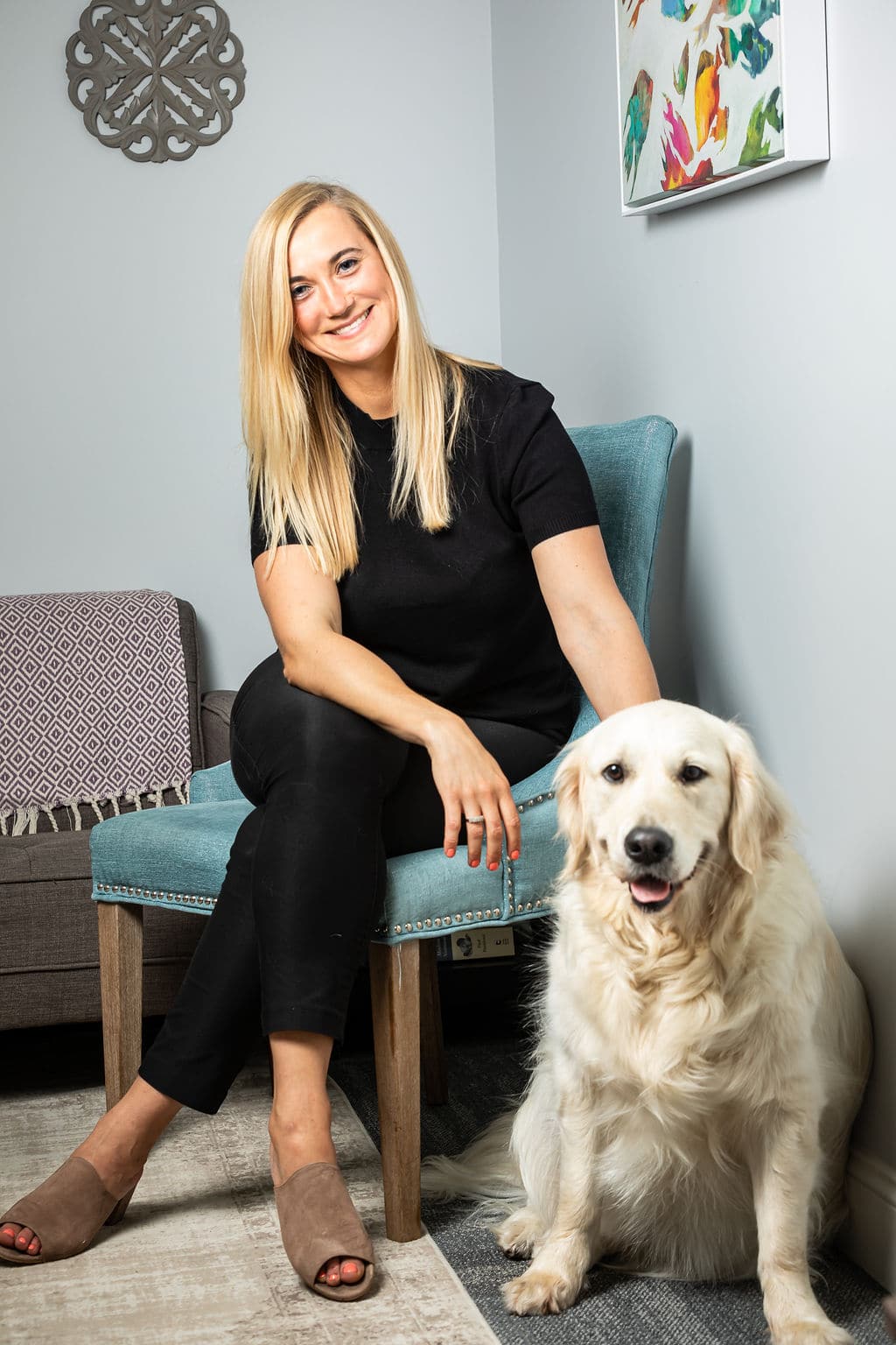 Therapist with Dog sitting next to chair