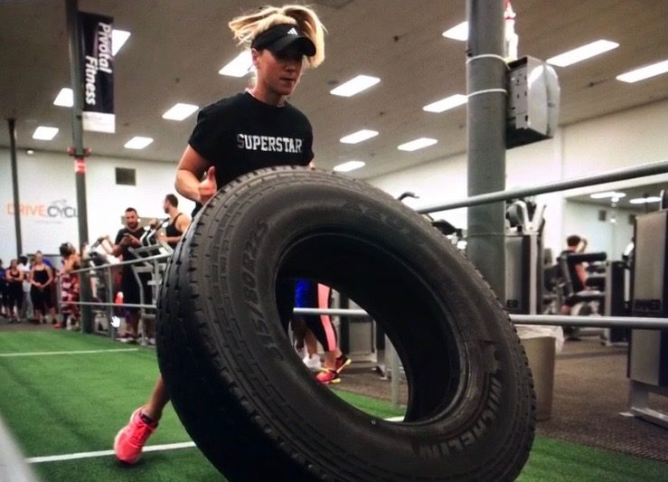 Therapist Kasia Tire Flipping in a CrossFit Competition